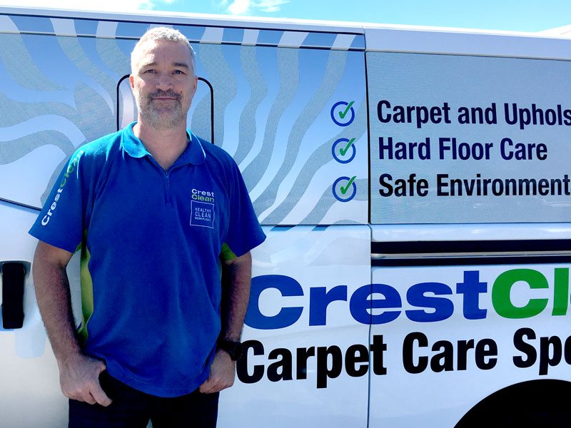 Carpet care expert Kent Wilkinson with his sign-written Nissan NV350 van.