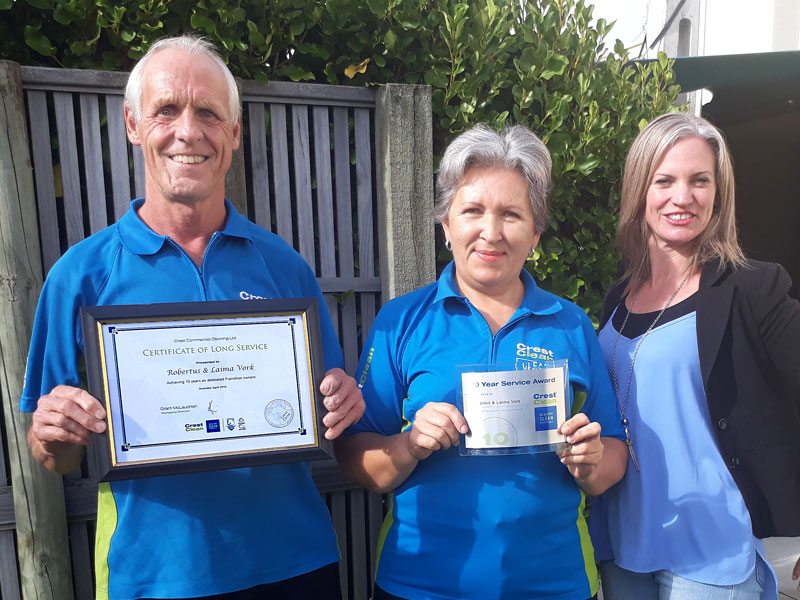 Robertus and Laima Vork receive their Certificate of Long Service from Aby Latu.