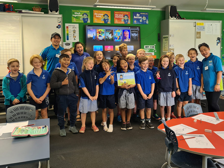 Group of school pupils with certificate.