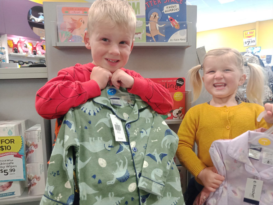 Children holding pyjamas.