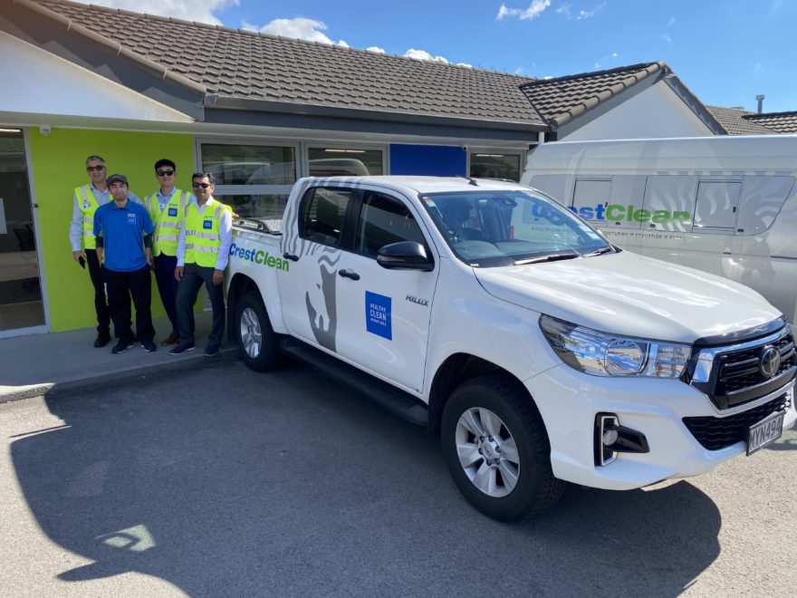 Ceaning personnel inspect vehicle.