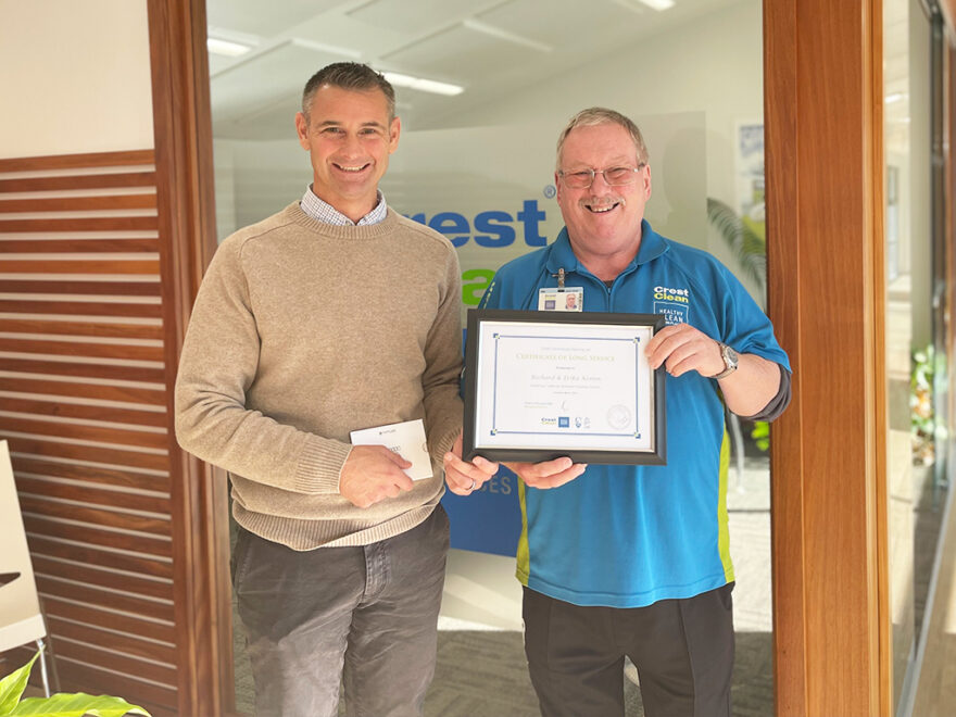 Cleaner being presented with long service certificate.