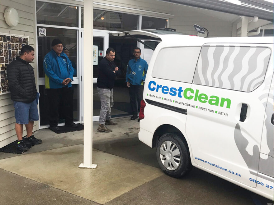 People looking at a cleaning van.