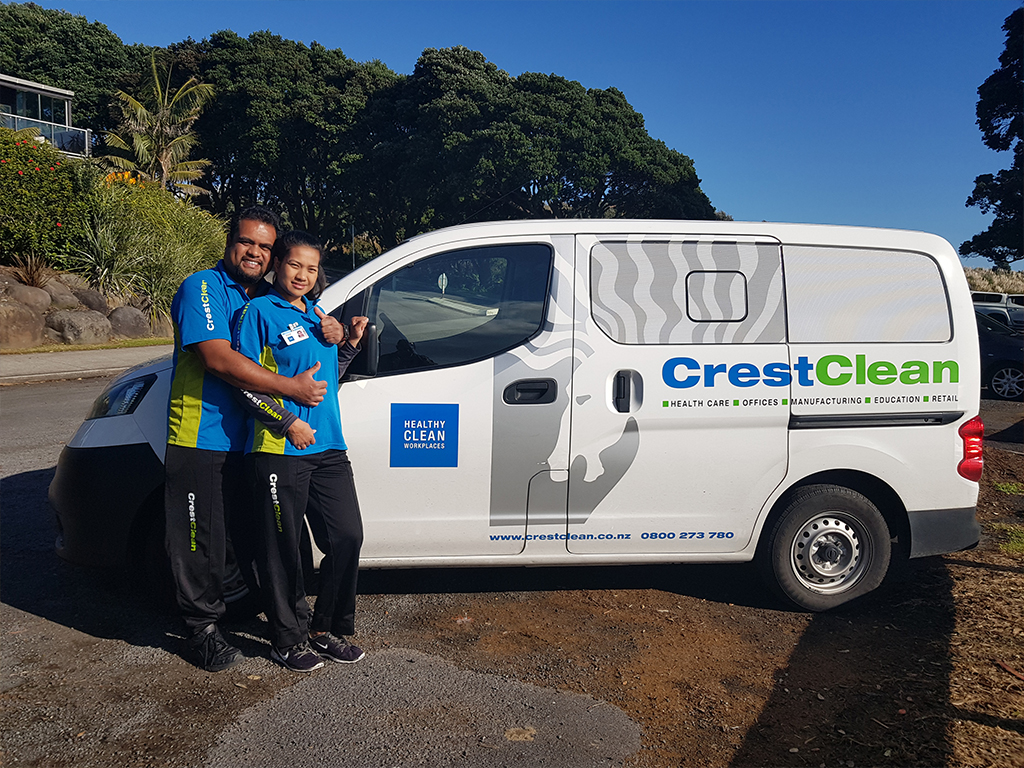 Cleaners standing by their van.