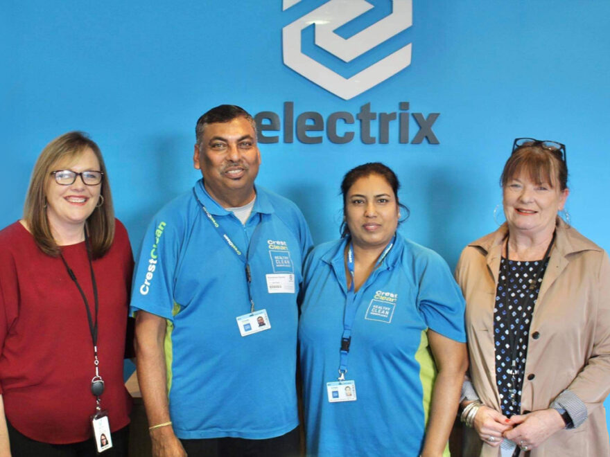 Cleaners stand alongside happy customers.