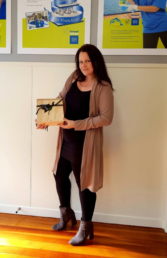 Woman holding gift hamper.