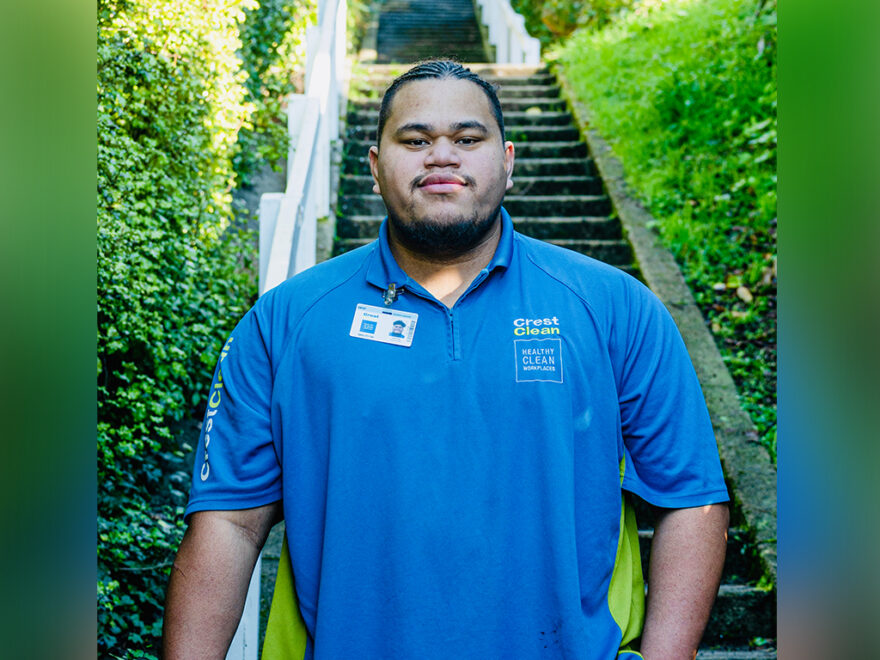 Cleaner standing outside in front of steps.