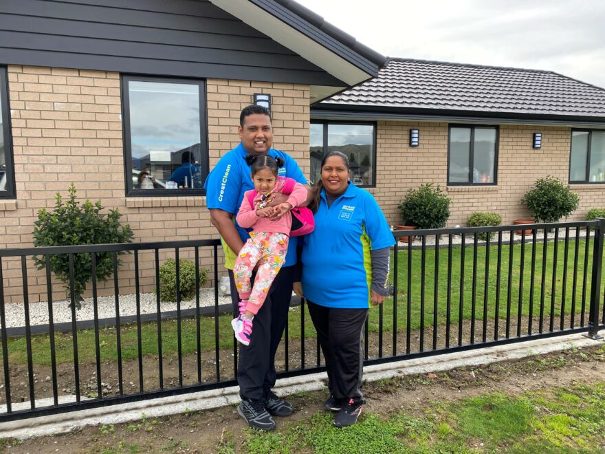 Family standing outside their house.