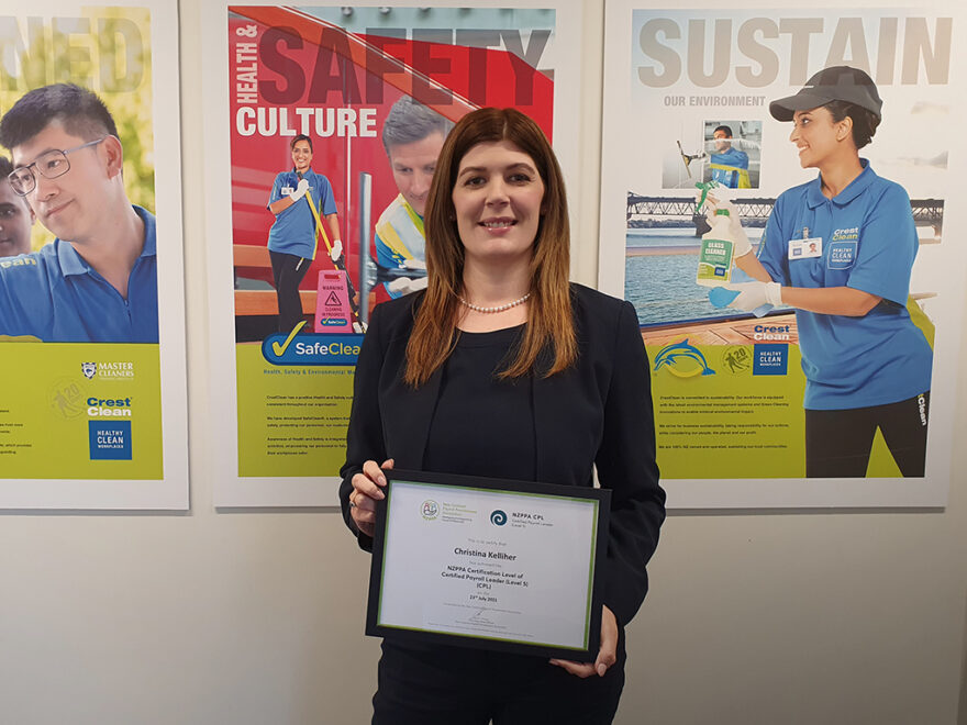 Woman holding framed certificate.