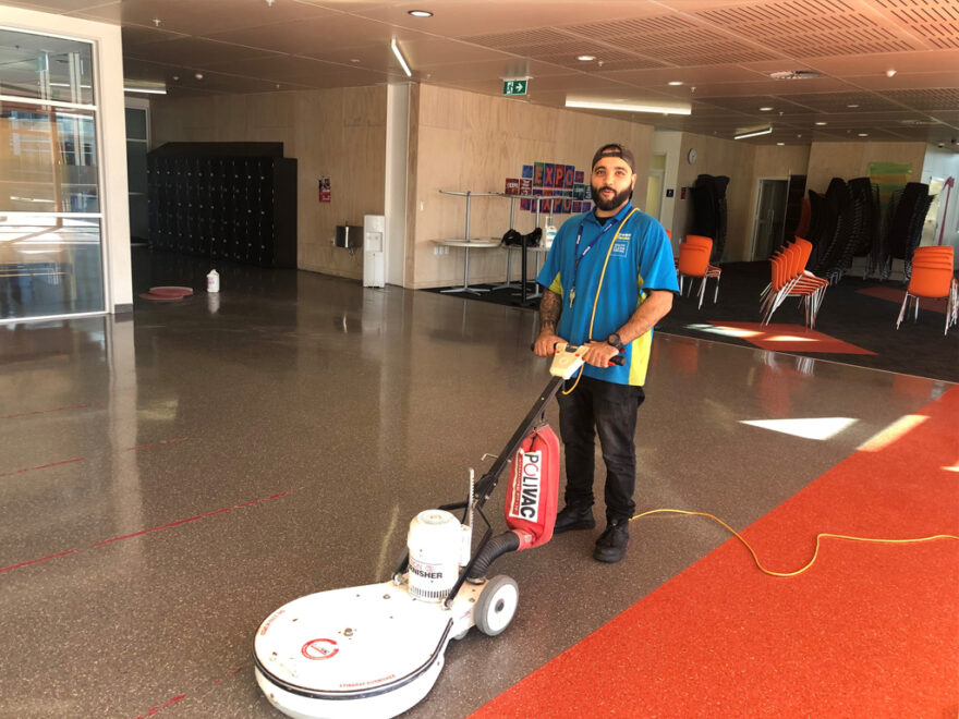 Cleaner using floor machine.