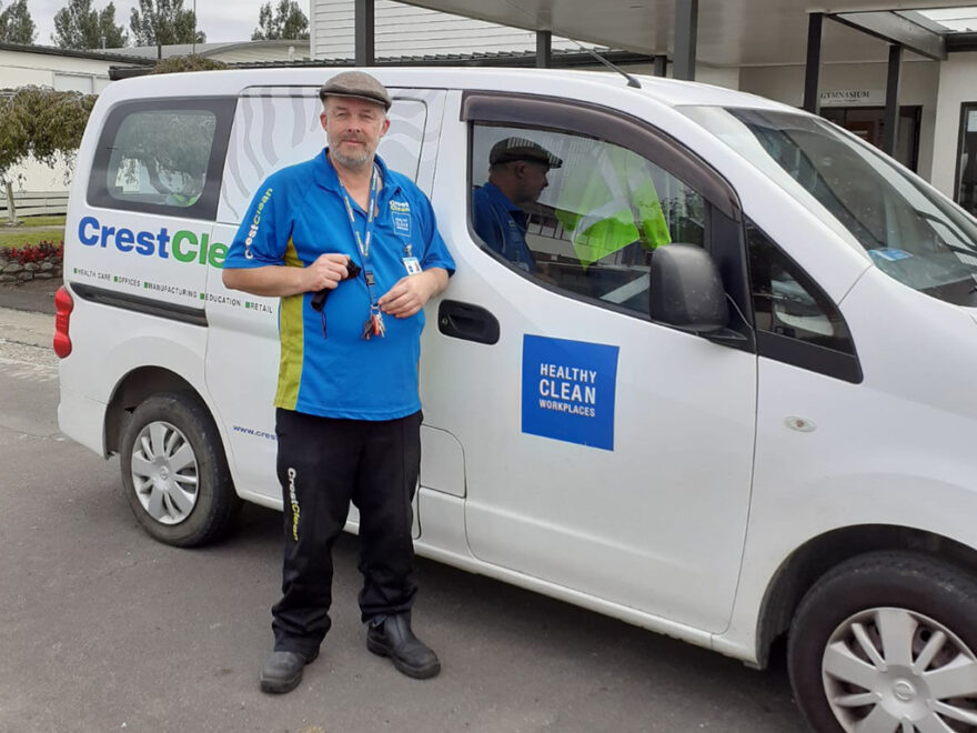 Cleaner standing by his van.