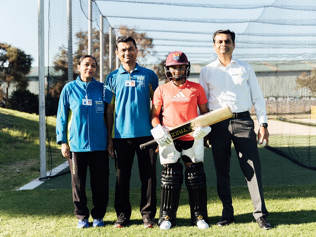 Cricketer standing with her family.