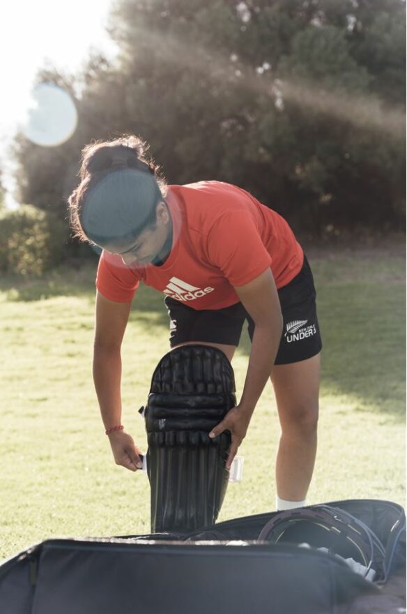 Cricketer packing her sports bag.