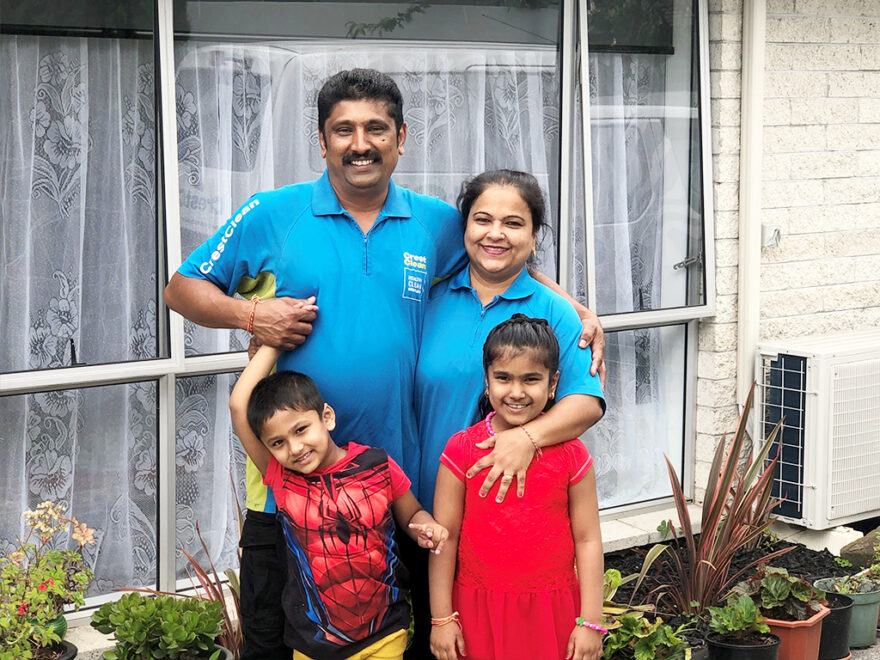 Family standing outside their home.