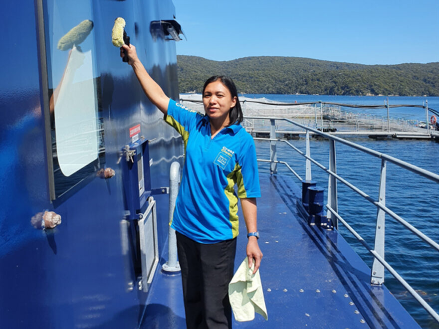 Cleaning a window on a barge.