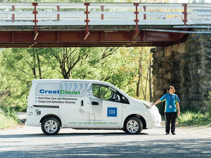 Woman standing next to van.