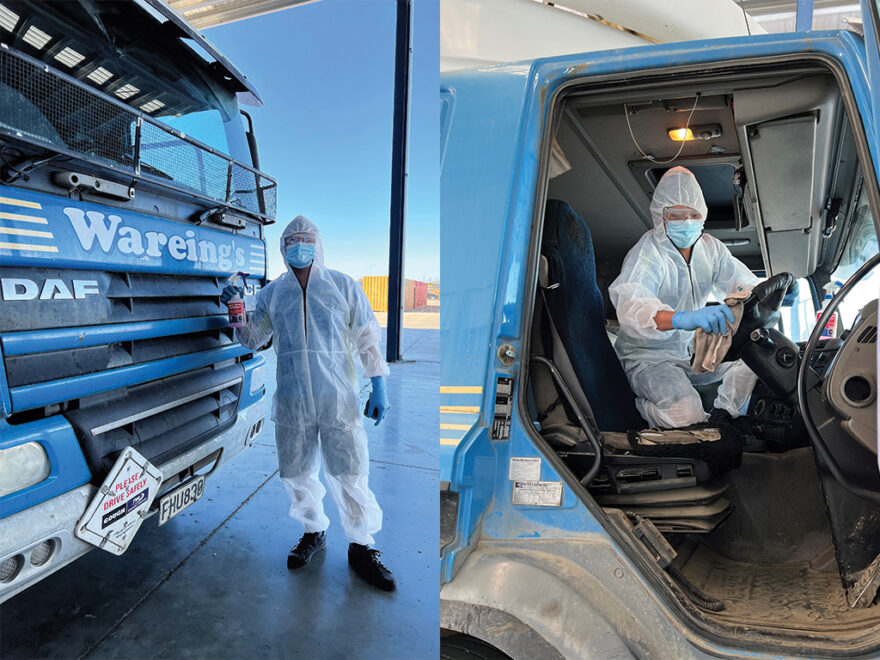 Man wearing PPE cleaning truck cab.