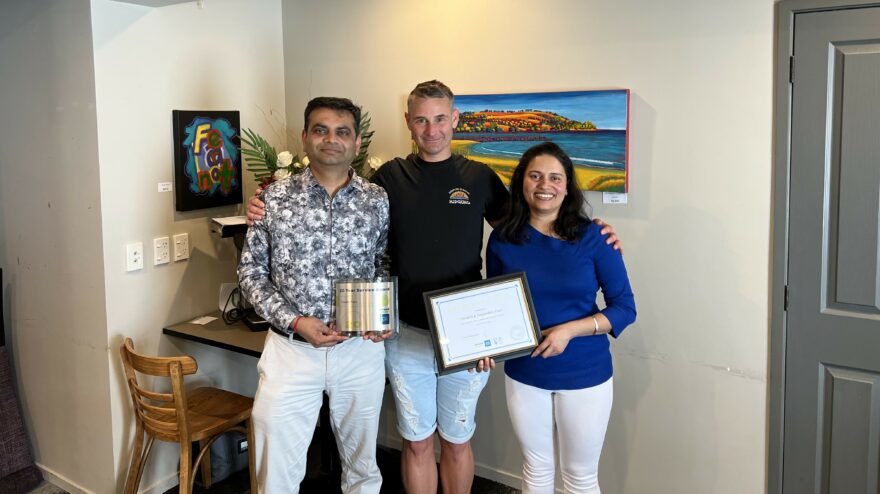 Tauranga Regional Master Franchisee Jan Lichtwark (centre) presents Pinakin and Falguniben Patel with with a 20-Year Long Service Award.