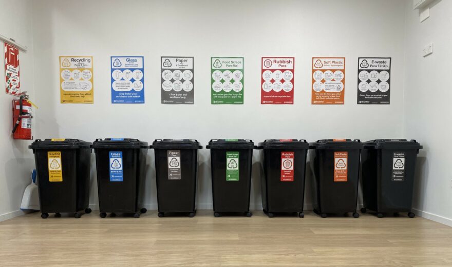 Centralised rubbish bin system using RecycleKiwi stickers and posters.